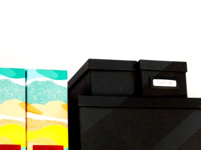 Pile Of Black Shoe Box Next To Wall