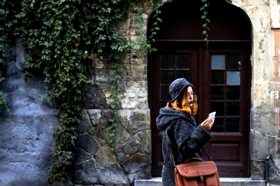 Woman Sitting In Front Of Building