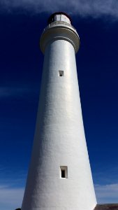 White Lighthouse In Low Angle Photography photo