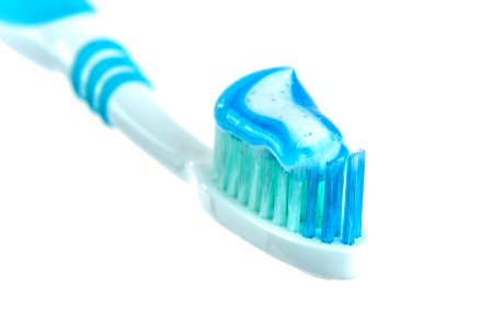 Blue And White Toothpaste On Toothbrush