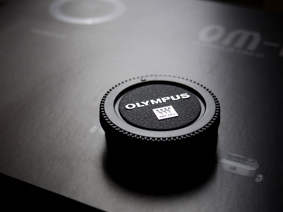 Olympus Camera Lens Cap Placed On Box