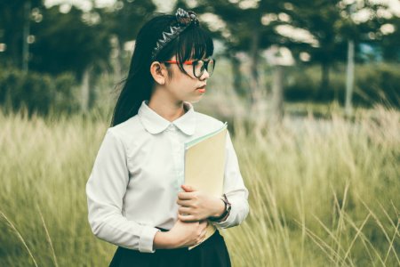 Asian Girl Outdoors Holding Folder photo