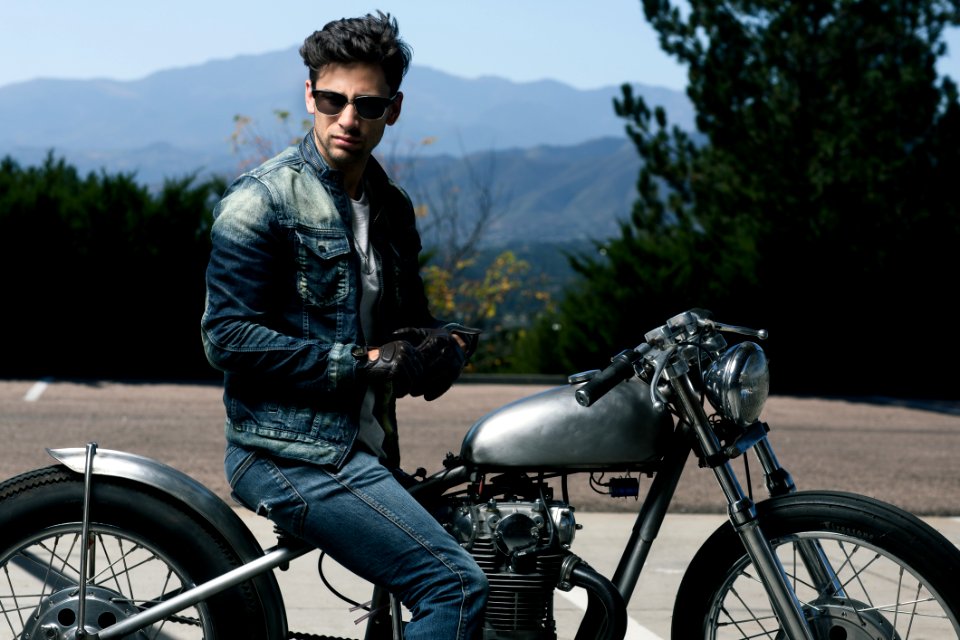Young Man Seated On Motorbike