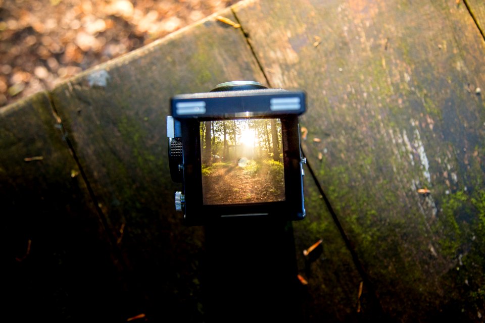 Black Camera On Brown Wooden Table