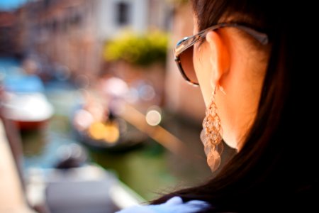 Woman Wearing Pendant Earrings And Sunglasses photo