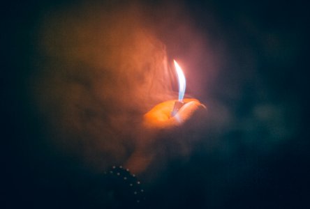 Hand Holding Lighter In Smoke photo