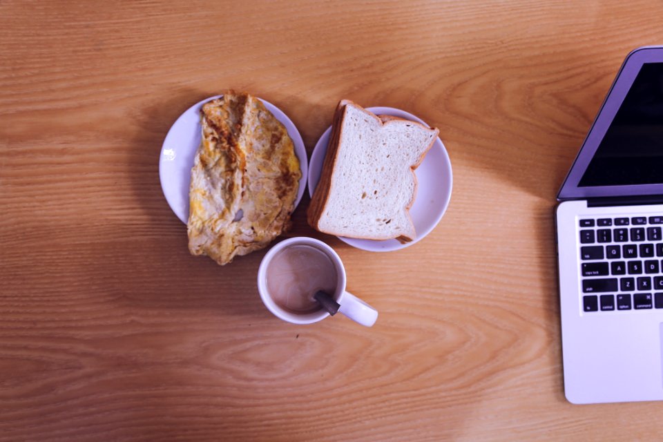 White Ceramic Mug Beside Bread On White Ceramic Saucer photo