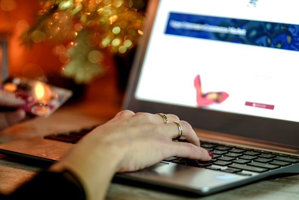 Right Hand With Gold Ring On Black And Grey Laptop Computer