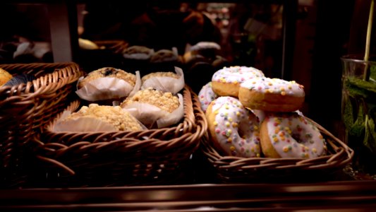 White Topped Doughnut Beside Peanut Cupcake