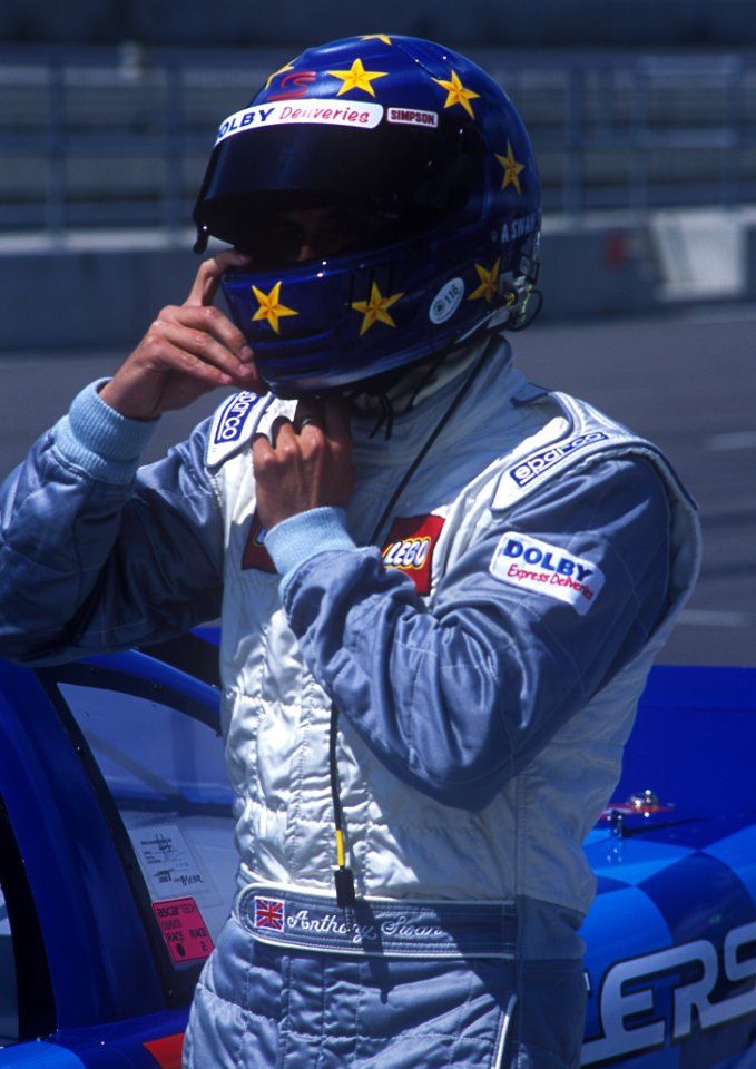 Man In Blue And And White Racer Suit Wearing His Blue And Yellow Star Full Face Helmet