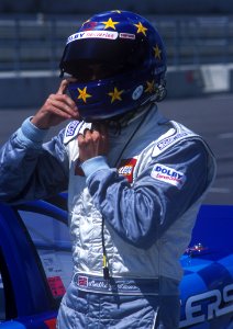 Man In Blue And And White Racer Suit Wearing His Blue And Yellow Star Full Face Helmet photo