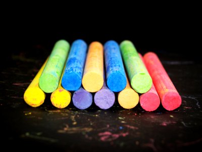 Pile Of Colored Chalk On Black Wooden Tabletop