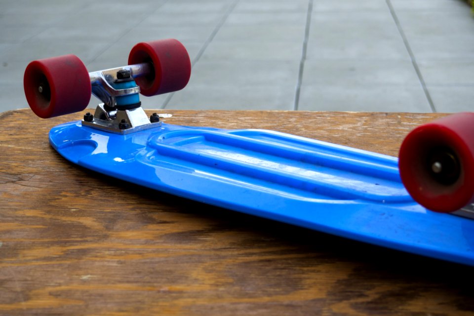 Blue Penny Board On Wooden Table