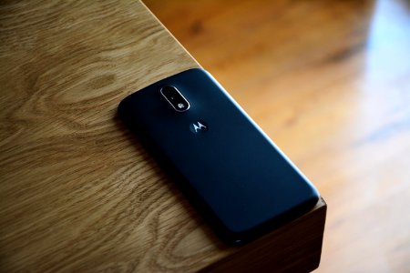 Black Motorola Smartphone On Top Of Brown Wooden Table photo