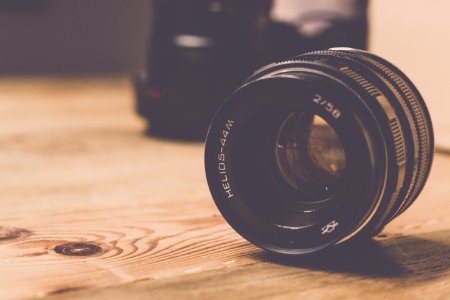 Black Helios 44m 258 Camera Lens On Brown Wooden Table photo