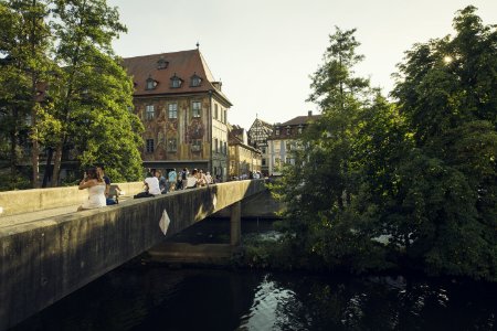 People Walking On Bridge Near The Town During Daytime photo