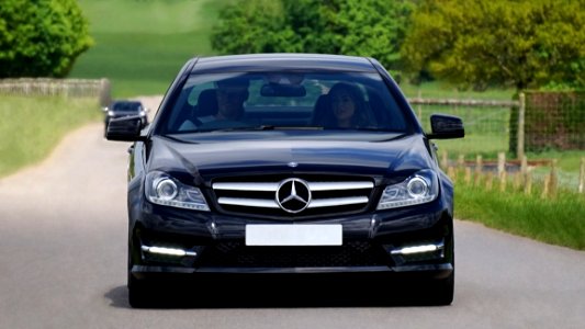 Black Mercedes Benz Car On Grey Asphalt Road During Daytime photo