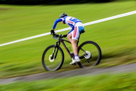 Man In Blue And White Long Sleeve Sweat Shirt Riding Black Hard Tail Bicycle photo