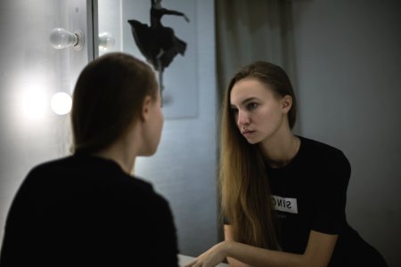 Woman In Black Shirt Facing Mirror photo