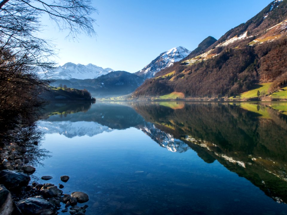 Mountain Peaks Reflecting In Lake