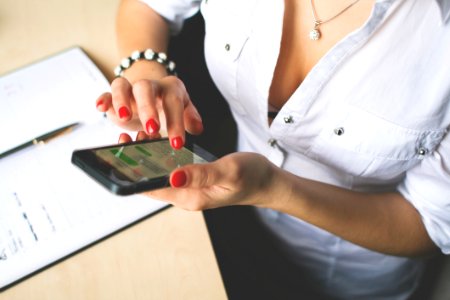 Woman In White Button Up Top And Holding Black Android Smartphone photo