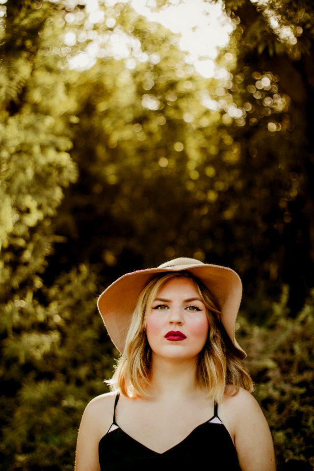 Woman In Black Dress Wearing Sunhat During Daytime photo