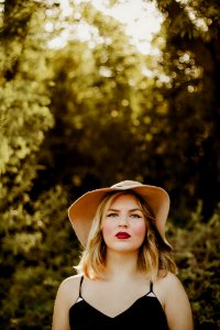 Woman In Black Dress Wearing Sunhat During Daytime