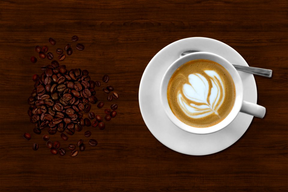 Brown And White Espresso In White Coffee Mug Beside Coffee Beans