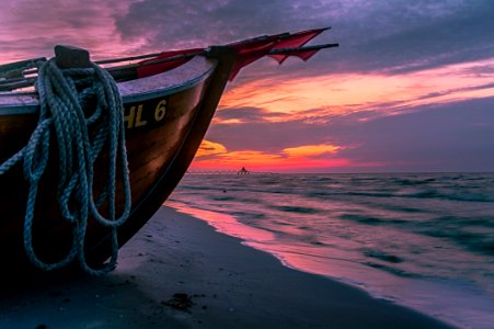 Brown Wooden Boat On Shore During Sunset photo