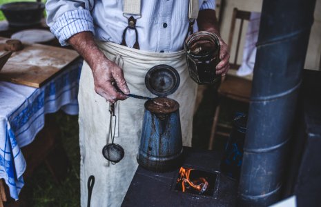 Man Holding Jar While Scooping On Kettle photo