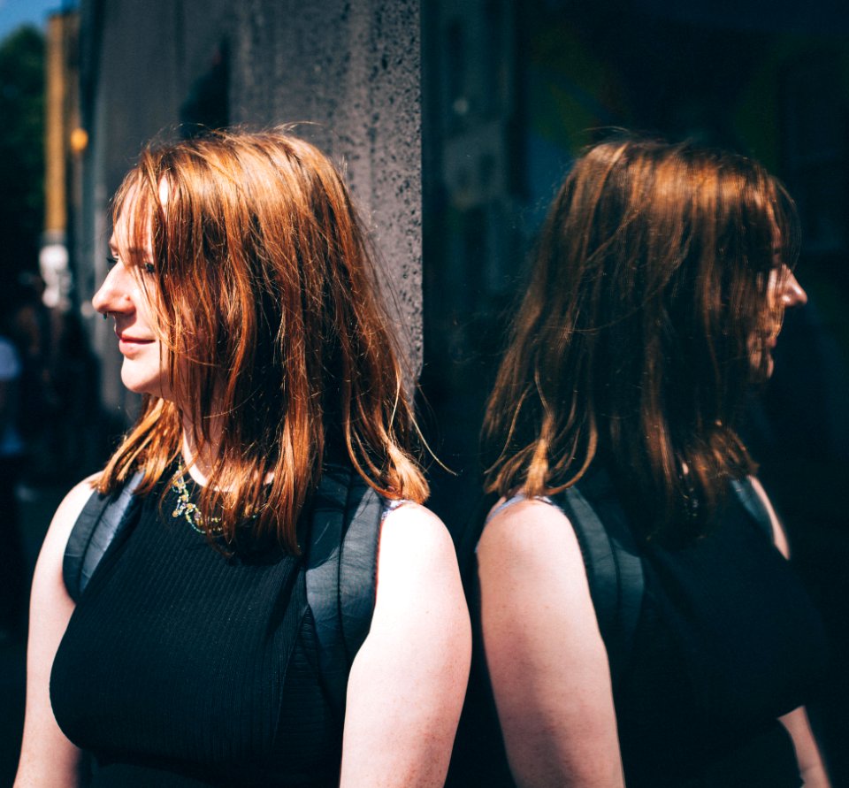 Woman In Black Sleeveless Top Wearing Black Backpack