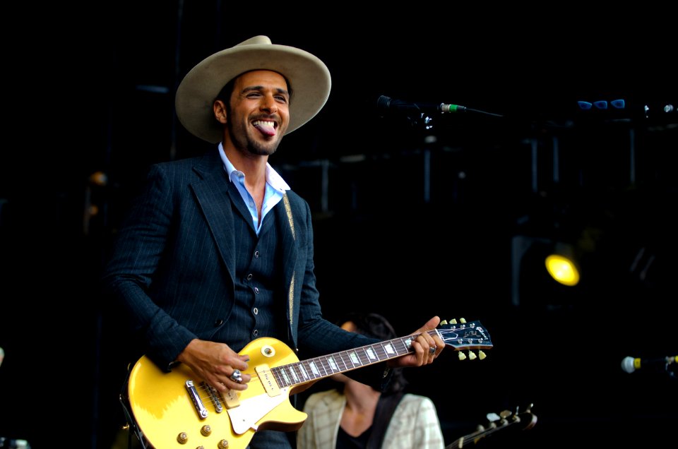 Main In Black Suit Jacket Playing Les Paul Electric Guitar