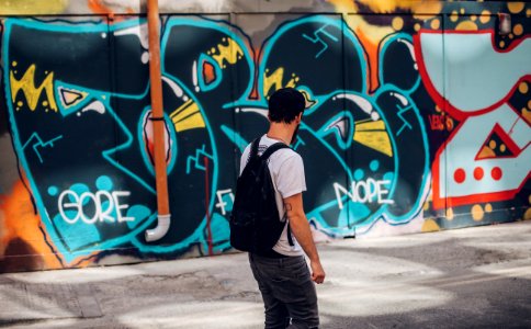 Man In Front Of Wall With Graffiti