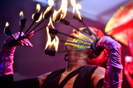 Red Haired Fire Dancer Blowing Rod With Flames