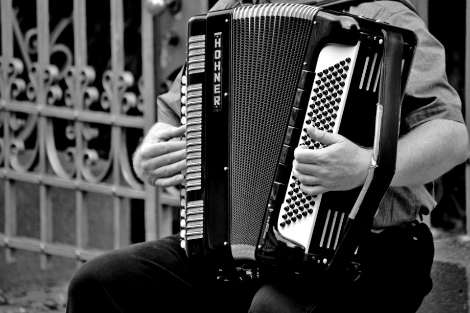 Person Playing A Horner Musical Intrument In Grayscale
