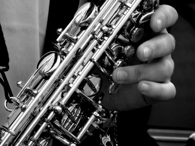 Person Holding Saxophone In Gray Scale Photography photo