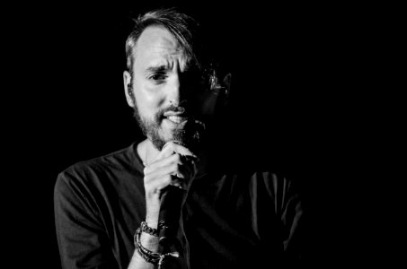 Grayscale Photo Of Man Holding Microphone photo