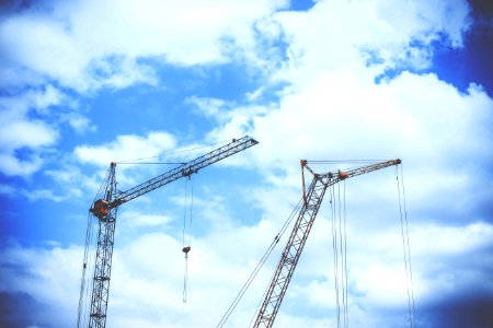 Gray Rectangular Power Crane With Blue Cumulus Clouds Above As Background During Daytime
