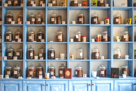 Assorted Jars On Blue Shelf Cabinets photo