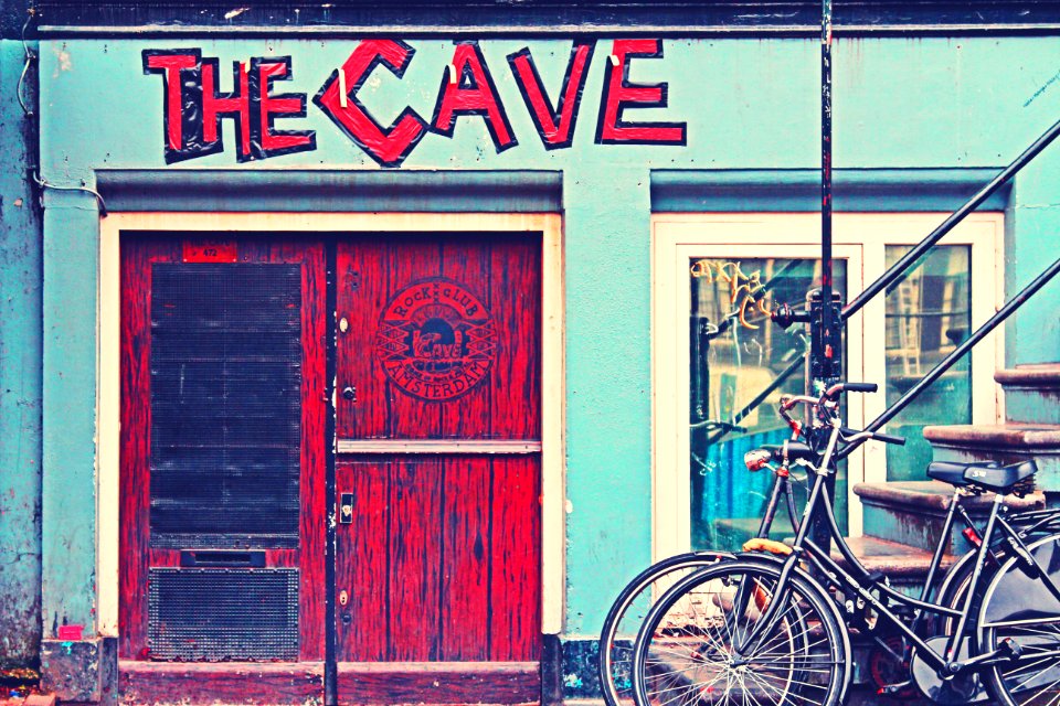 Black Beach Cruiser Bike Beside The Red Wooden Door Outside