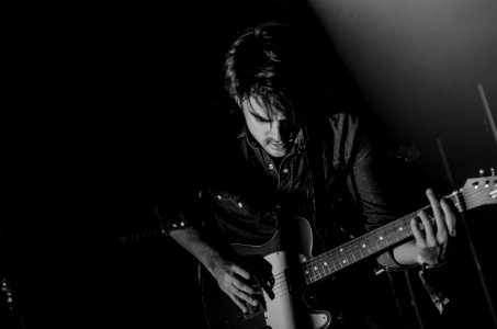 Grayscale Photo Of Man Playing Electric Guitar