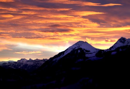 Snow Mountain Under Orange Skies