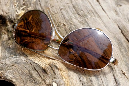 Silver Aviator Sunglasses On Top Of Wooden Surface photo