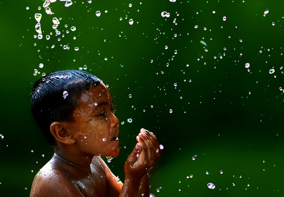 Wet Boy With Water Droplets In Slow Motion Photography