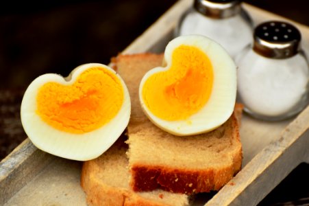 Boiled Egg On Top On Bread Beside Salt Shaker photo
