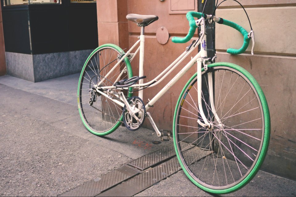 White And Green Bike Leaning On Wall