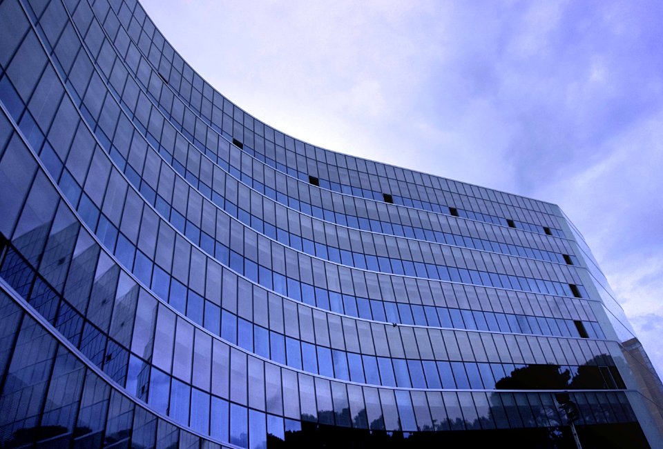 Fish Eye View Photo Of Glass High Story Building Over White Cloudy Sky During Daytime