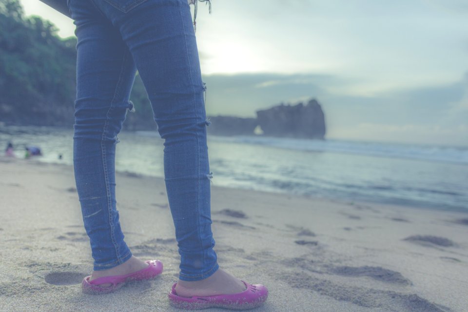 Person In Blue Jeans And Pink Flats In Front Of Seashore