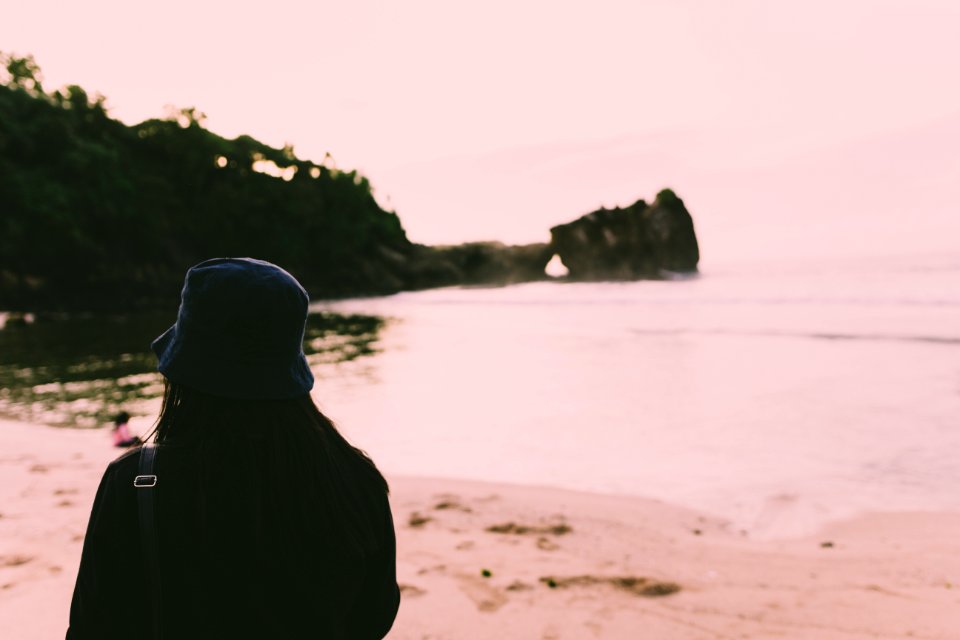 Silhouette Of Person Standing On Seashore During Daytime photo