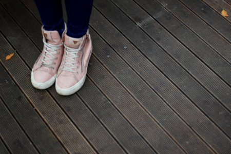 Person Wearing Pink And White High Top Sneakers photo